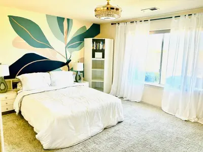 a bedroom with a white bed and a large window at Silver Lakes Oasis with Resort Style Amenities in Helendale