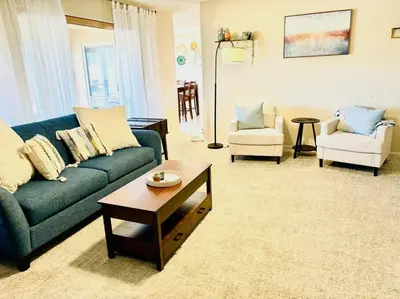 a living room with a blue couch and two chairs at Silver Lakes Oasis with Resort Style Amenities in Helendale