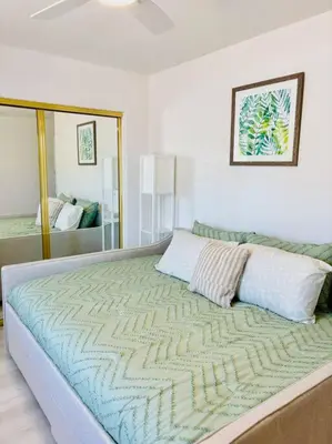 a large bed in a bedroom with a mirror at Silver Lakes Oasis with Resort Style Amenities in Helendale