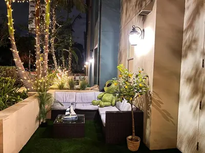 a small garden with a white couch and plants at Beautiful 2 BD 3 Beds in Heart of Encino 105 in Encino