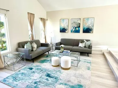 a living room with a couch and a rug at Family Paradise near Disneyland with Sparkling Pool in Del Prado Bolsa