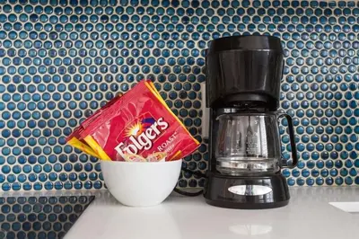 a coffee maker and a packet of chips next to a cup at Sunny Studio in the Heart of Venice Beach - #6 in Los Angeles