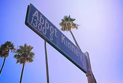 a blue street sign with palm trees in the background at Sunny 1 Bedroom in the Heart of Venice Beach - #1 in Los Angeles