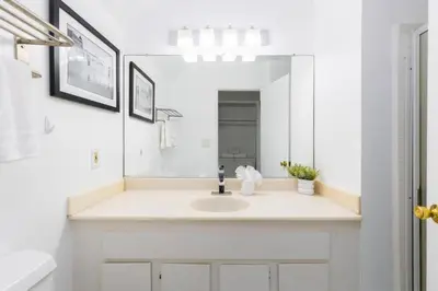 a white bathroom with a sink and a mirror at Sunny 1 Bedroom in the Heart of Venice Beach - #1 in Los Angeles