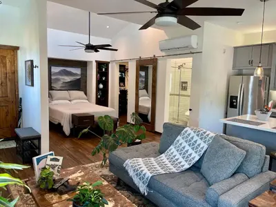 a living room with a couch and a bed at Cozy Guesthouse with Rooftop Deck in Los Angeles
