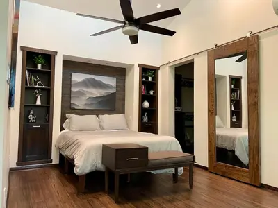 a bedroom with a bed and a ceiling fan at Cozy Guesthouse with Rooftop Deck in Los Angeles