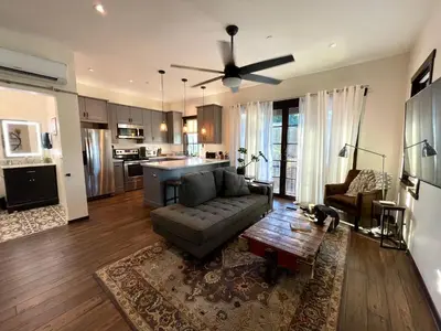 a living room with a couch and a ceiling fan at Cozy Guesthouse with Rooftop Deck in Los Angeles