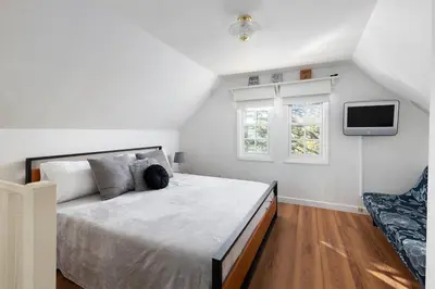 a bedroom with a large bed and a tv at Gingerbread Gardens in Twin Peaks