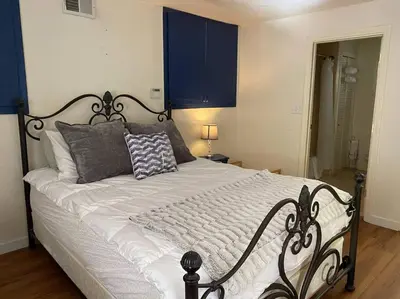 a bedroom with a large bed with blue cabinets at Hideaway at Gingerbread Gardens in Twin Peaks