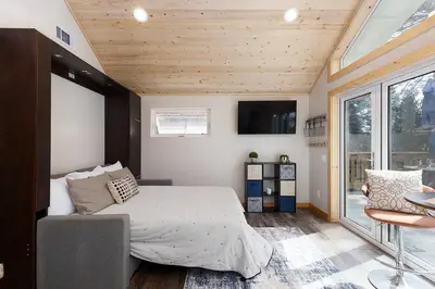 a bedroom with a bed and a large window at One With Nature in Crest Park