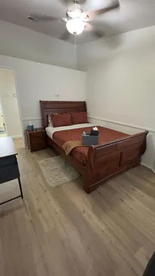 a bedroom with a large wooden bed in a room at Oasis Home near Rancho Vista in Quartz Hill