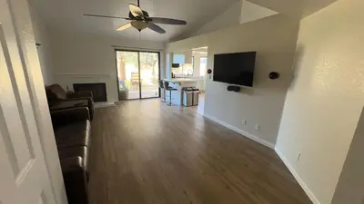 a living room with a couch and a ceiling fan at Oasis Home near Rancho Vista in Quartz Hill