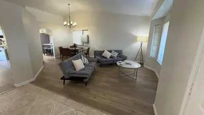 a living room with two couches and a table at Oasis Hm near Rancho Vista- Shared Hm in Palmdale