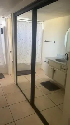 a reflection of a bathroom with a sink and a mirror at Oasis Hm near Rancho Vista- Shared Hm in Palmdale