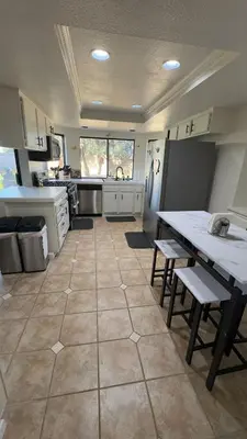 a large kitchen with a table and chairs in it at Oasis Hm near Rancho Vista- Shared Hm in Palmdale
