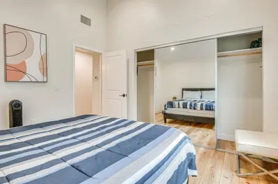 a bedroom with a bed and a chair and a mirror at 10 Mi to Dtwn LA Cat-Friendly Rosemead Cottage in Rosemead