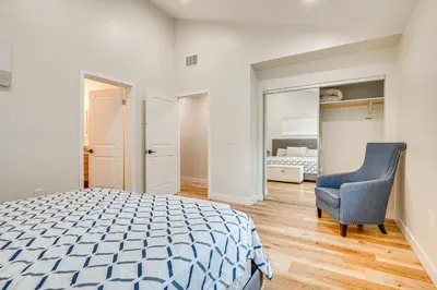 a bedroom with a bed and a blue chair at 10 Mi to Dtwn LA Cat-Friendly Rosemead Cottage in Rosemead