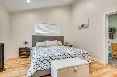 a bedroom with a large bed with a blue and white blanket at 10 Mi to Dtwn LA Cat-Friendly Rosemead Cottage in Rosemead