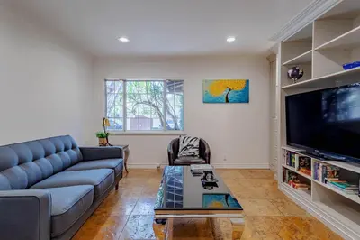 a living room with a couch and a tv at Cozy Home with Pool and Jacuzzi Minutes from Universal Studios in Los Angeles