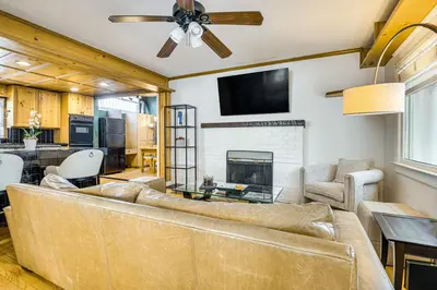 a living room with a couch and a fireplace at Walk to Abbot Kinney Tranquil Cottage in Venice! in Los Angeles