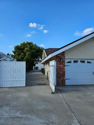 a garage with two white garage doors and a driveway at Spacious 2 story 1 bedroom home with pool in Rio Bravo