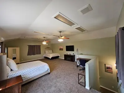 a bedroom with two beds and a flat screen tv at Spacious 2 story 1 bedroom home with pool in Rio Bravo