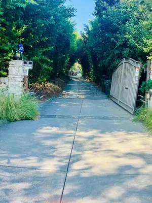 an empty sidewalk with an archway in the middle at 550sqft Studio Style ADU GuestHouse 2Acre Estate View Deck - Female Share Indoor - Men Share Outdoor in Los Angeles