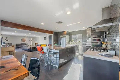a kitchen with a table and some chairs in it at Middlebury Heights with Pool in Los Angeles