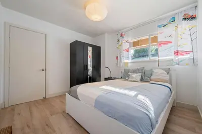 a bedroom with a large bed and a window at Middlebury Heights with Pool in Los Angeles