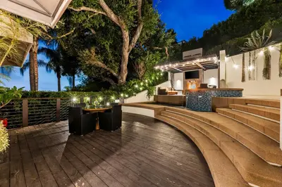 an outdoor patio with lights and a table and chairs at West Hollywood Hills Jacuzzi and Beautiful View in Los Angeles