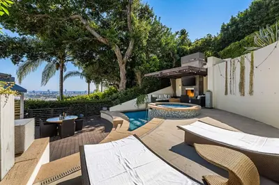 an outdoor patio with chairs and a swimming pool at West Hollywood Hills Jacuzzi and Beautiful View in Los Angeles