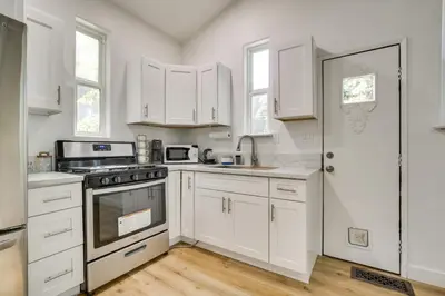 a kitchen with white cabinets and a stove at Lake Arrowhead Hideaway with Deck and Hot Tub in Lake Arrowhead