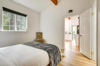 a white bedroom with a bed and a window at Lake Arrowhead Hideaway with Deck and Hot Tub in Lake Arrowhead