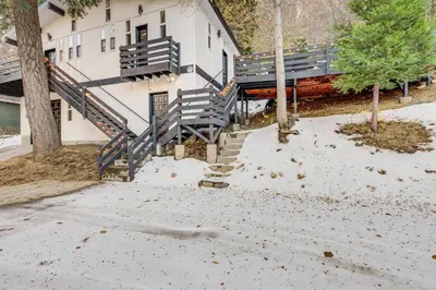 a building with stairs and a bench in the snow at Lake Arrowhead Hideaway with Deck and Hot Tub in Lake Arrowhead