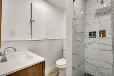 a white bathroom with a sink and a shower at 2 Mi to Water Lake Arrowhead Studio in Lake Arrowhead
