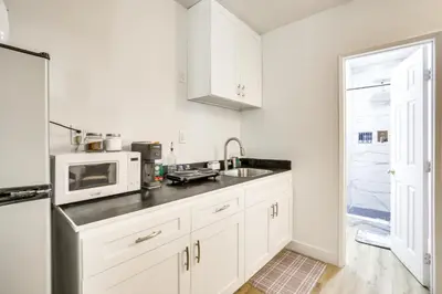 a kitchen with white cabinets and a microwave at 2 Mi to Water Lake Arrowhead Studio in Lake Arrowhead