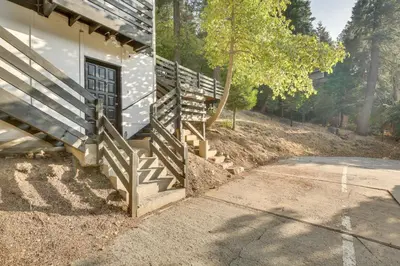 a porch of a house with a wooden fence at 2 Mi to Water Lake Arrowhead Studio in Lake Arrowhead