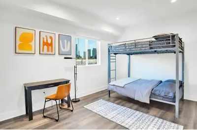 a bedroom with a bunk bed and a desk at Fresh & New Downtown LA Condo! in Los Angeles