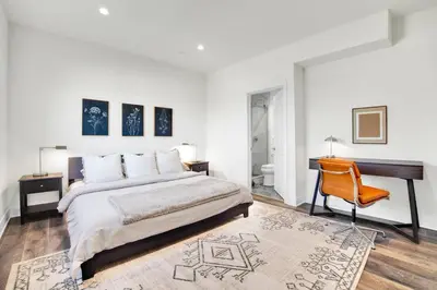 a bedroom with a bed and a desk and a chair at Fresh & New Downtown LA Condo! in Los Angeles