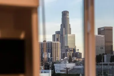 a view of a city skyline from a window at Fresh & New Downtown LA Condo! in Los Angeles