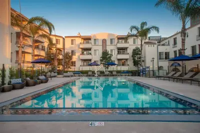 a swimming pool in front of some apartment buildings at Cozy 2 Bedroom 2 Bathroom Condo with Pool, Gym, Spa in Los Angeles
