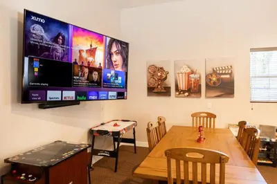 a room with a table and a flat screen tv at 37 - Foxy Farm Ranch home in Big Bear Lake
