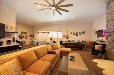 a living room with a couch and a pool table at 37 - Foxy Farm Ranch home in Big Bear Lake