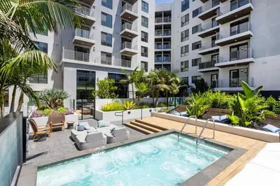 an apartment patio with a swimming pool and a building at Blueground Long Beach pool gym nr groceries LAX-1256 in Los Angeles