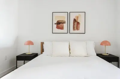 a bedroom with a white bed and two lamps at Blueground Long Beach pool gym nr groceries LAX-1256 in Los Angeles