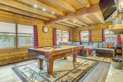 a living room with a pool table in a cabin at Cabin about 1 Mi to Lake Gregory and Hiking! in Crestline