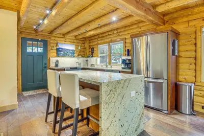 a kitchen with a counter and a refrigerator at Cabin about 1 Mi to Lake Gregory and Hiking! in Crestline