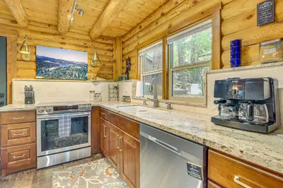a kitchen with a stove and a sink at Cabin about 1 Mi to Lake Gregory and Hiking! in Crestline