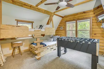 a bedroom with a bunk bed and a ping pong table at Cabin about 1 Mi to Lake Gregory and Hiking! in Crestline