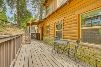 a wooden deck with a table and chairs on it at Cabin about 1 Mi to Lake Gregory and Hiking! in Crestline